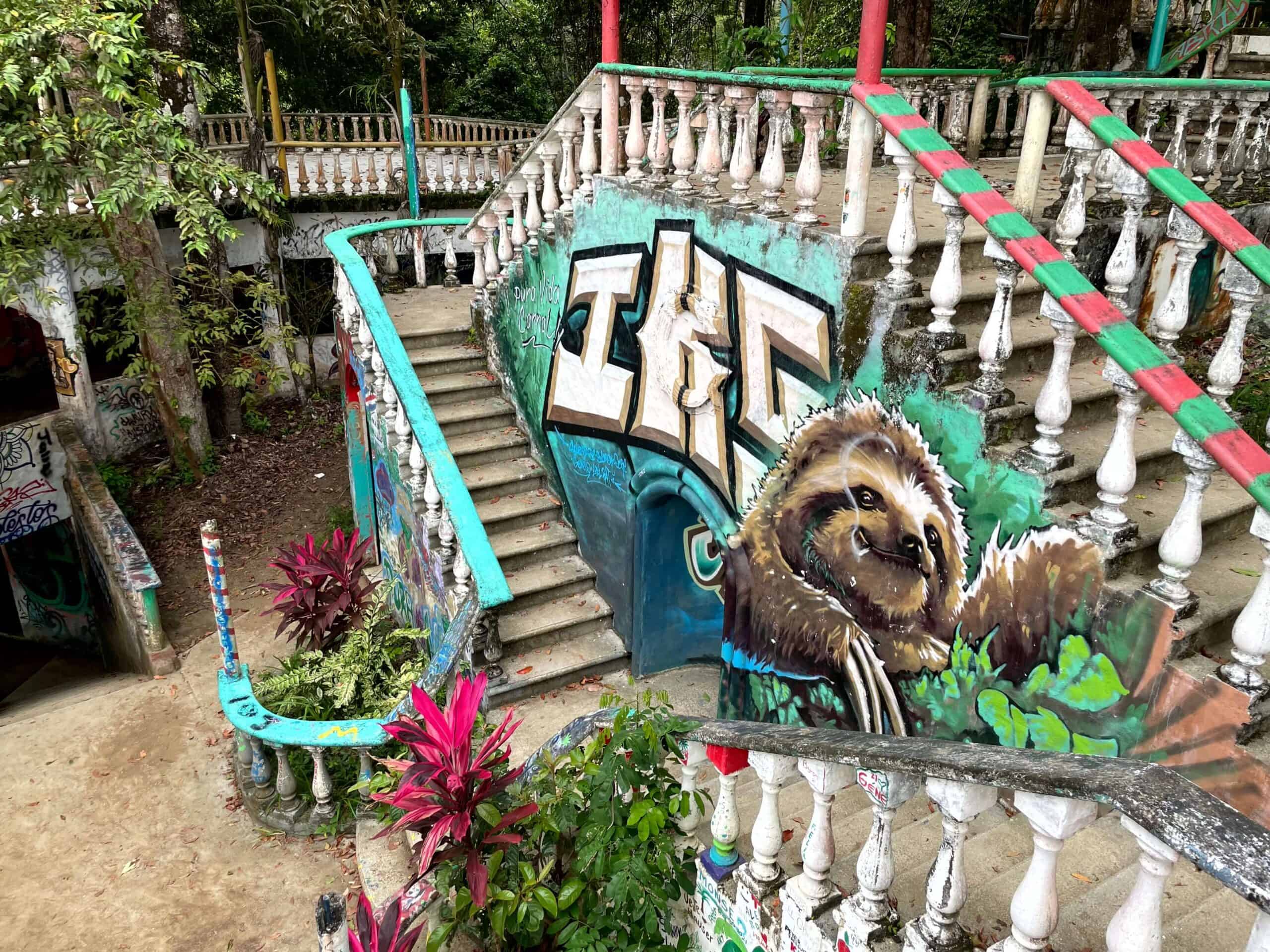 Jaco Costa Rica - A double staircase at El Miro with colourful graffiti including a sloth 