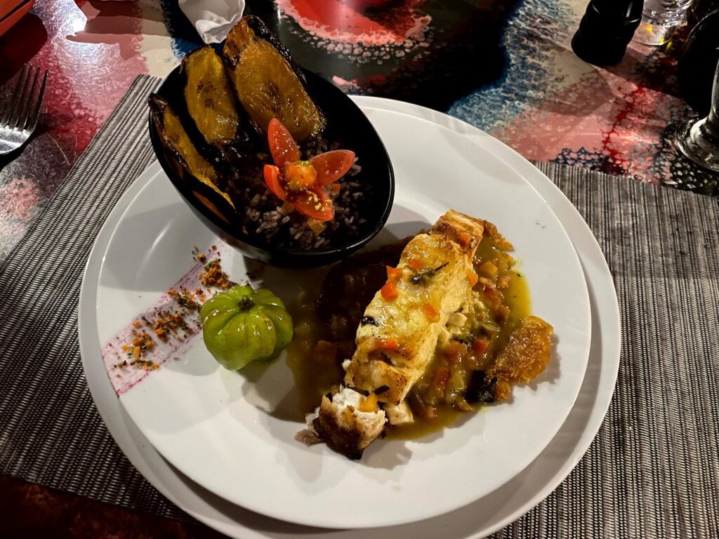 Caribbean "Rice and Beans" served with fish, fried plantains, and a habanero pepper