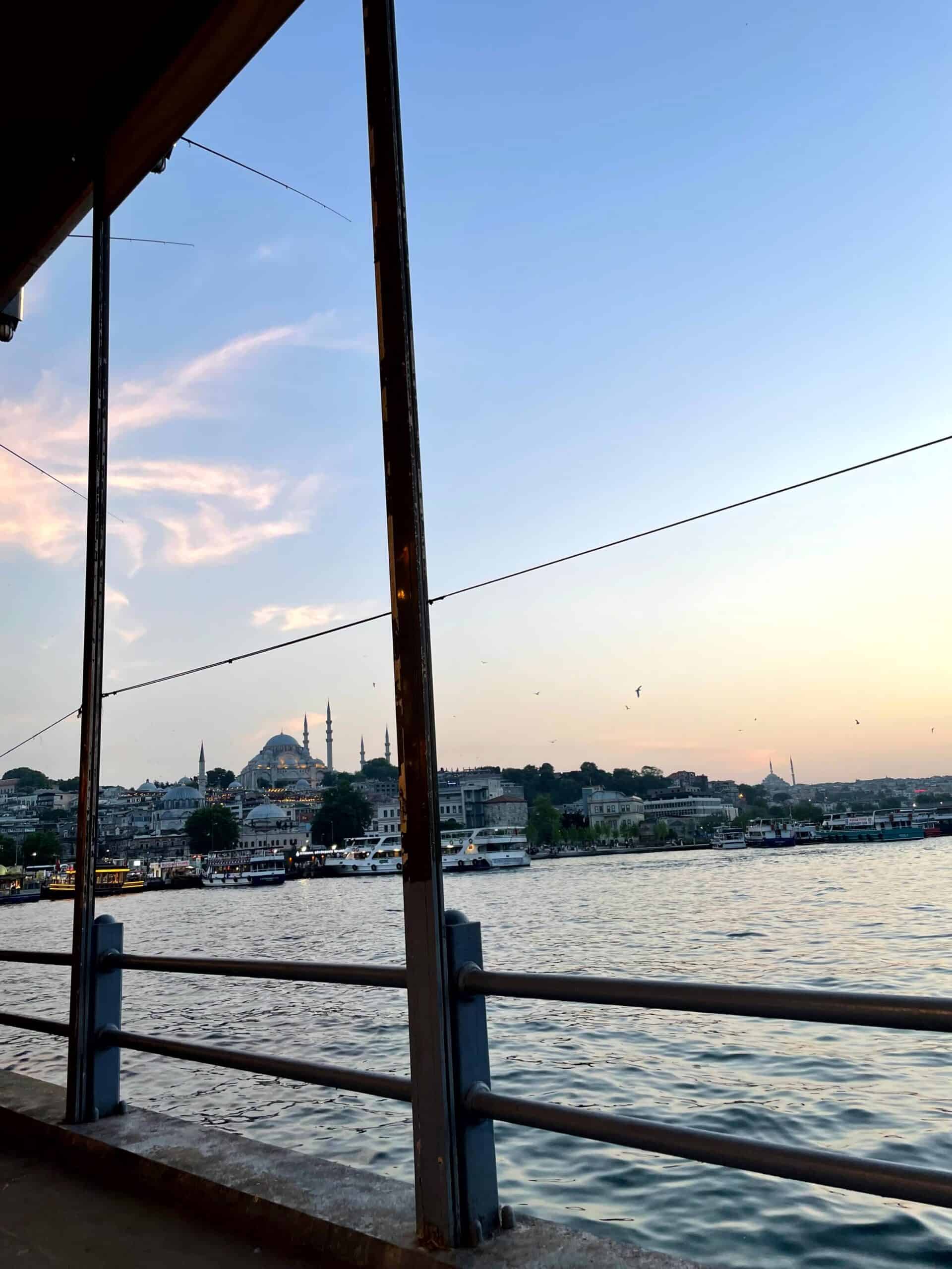 The view of Yeni Cami (New Mosque) from Galata Bridge at sunset.