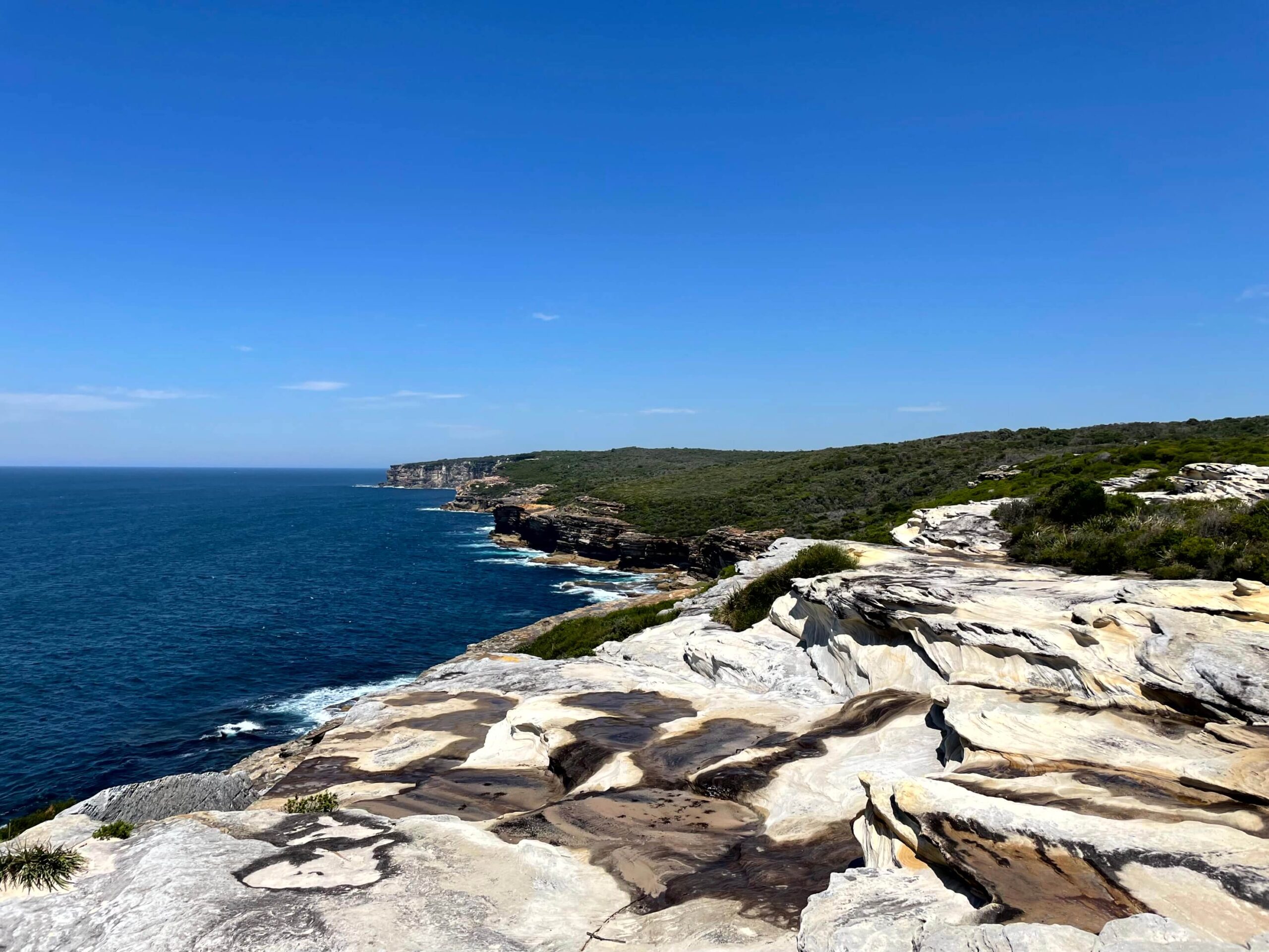 A rocky coastline and deep blue ocean along the Coast Track in the Royal National Park.
