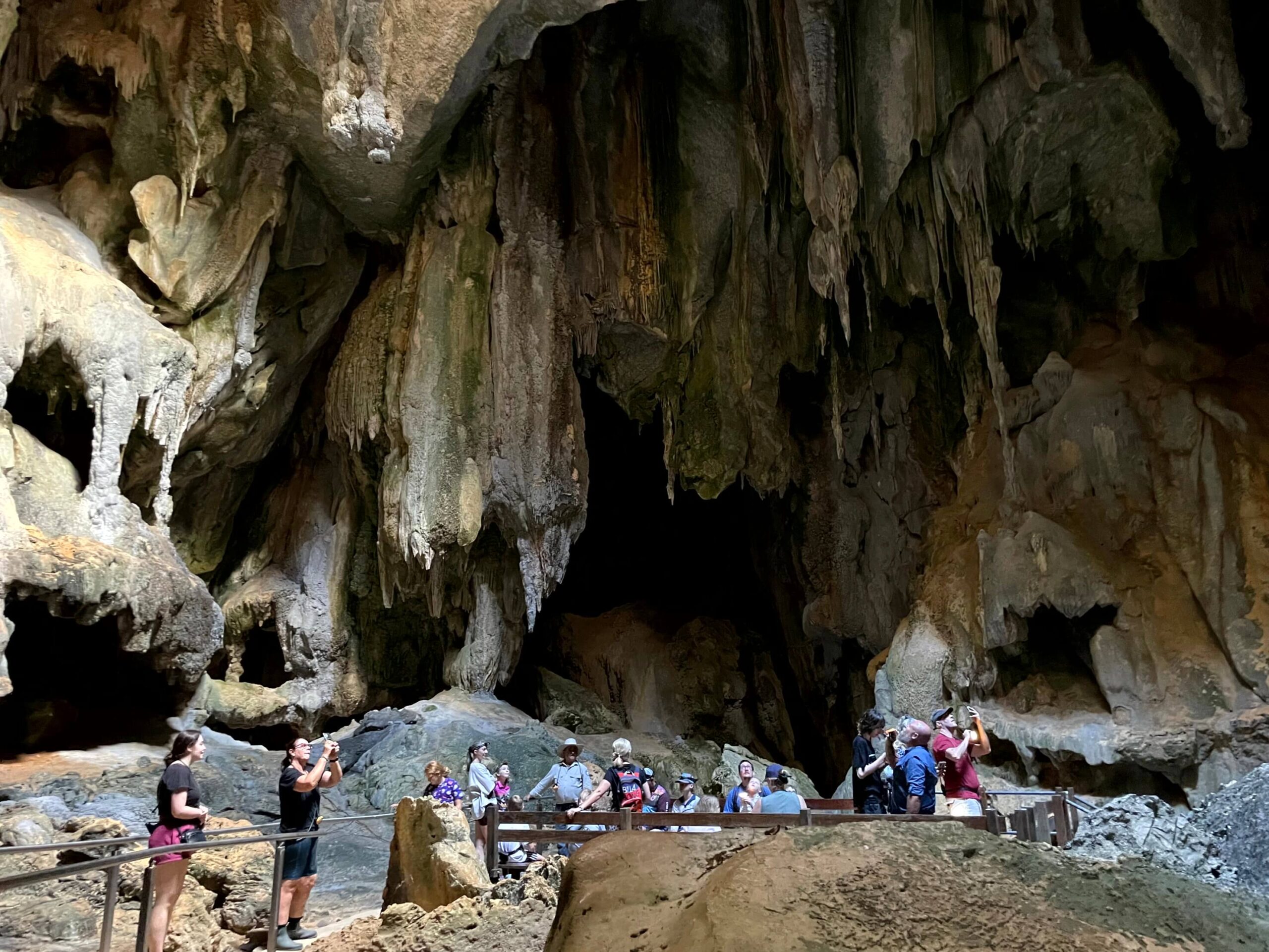 A small tour group inside the cavernous Picnic Chamber in the Royal Arch Cave system.